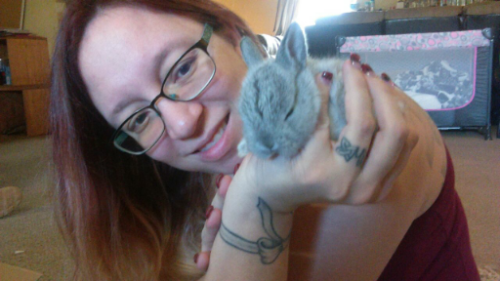 Rebel holding a small bunny inside the childcare room